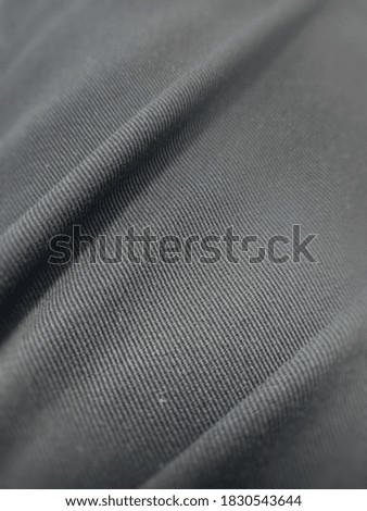 The surface of the black cloth closely photographed.