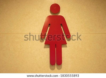 Red sign of women restroom with brown background. Toilet for girls. Bathroom for ladies.