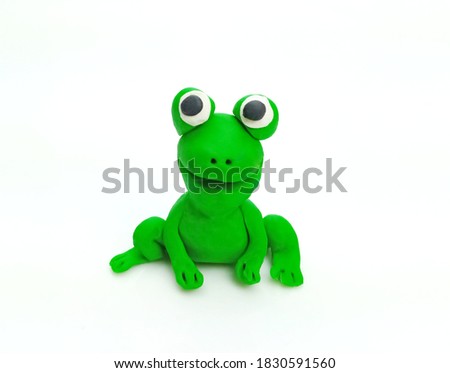 Plasticine happy green frog cartoon isolated on white background.