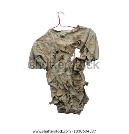 A clothes hanger hangs old clothes ragged on a white, rag. Royalty-Free Stock Photo #1830604397