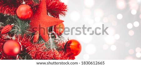 Merry Christmas holiday with red star on the tree, toy socks, Merry Christmas on the bokeh background happy New Year and Family happiness festival  background Beautiful decorations.