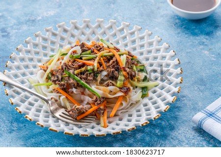 Oriental duck salad with rice noodles, vegetables and hoisin sauce