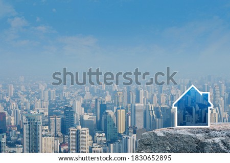 House icon with copy space on rock mountain over modern city tower, office building and skyscraper, Business real estate concept