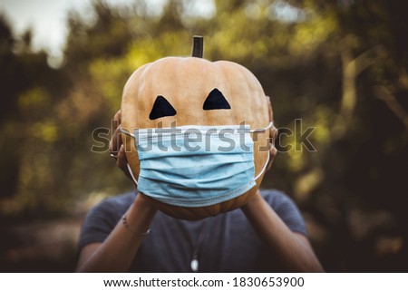 halloween 2020 pumpkin with a mask due to the covid 19 , coronavirus