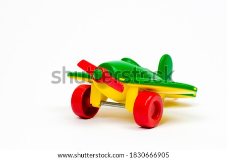 Children's toy plane of green color on a white background. Kids toys.