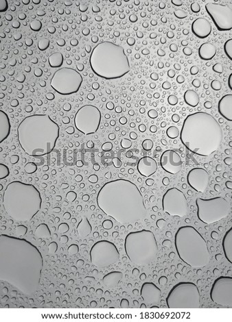 Water droplets on glass in rainy days Royalty-Free Stock Photo #1830692072