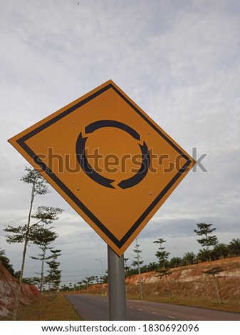 Yellow Roundabout Signboard At Highway