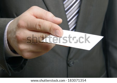 Businessman handing a blank business card