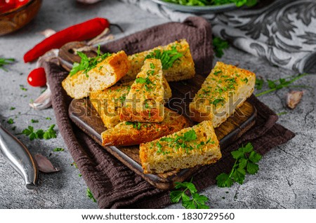 Delicious and simple dish, garlic baguette with fresh herbs and butter