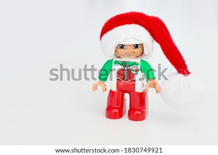 Christmas mini figure with santa hat isolated on white background, building blocks figure.