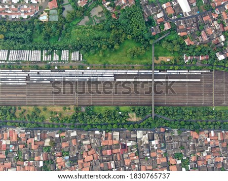 Aerial drone top view of KRL Commuter Line Jabodetabek with JR205 electric train on the track Dipo Depok Depot, West Java, Indonesia