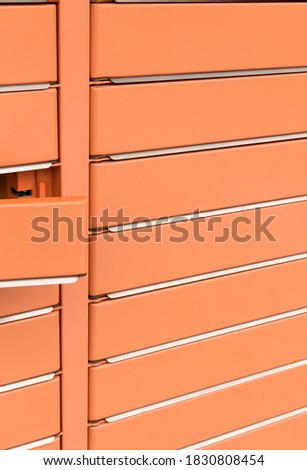 Post office box, the door is open. Orange post box for rentals. Post box lockers for parcels that the recipient can pick up there.
