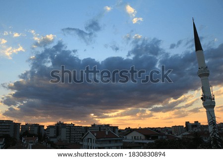 view of the shapes formed by the sunset and clouds over the city.