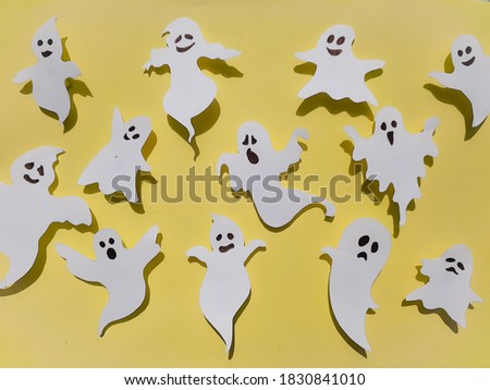 Halloween Ghosts On Yellow Color Background Stock Photo