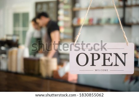 Signboard of tell open shop welcome in coffee shop. Business in asian with signboard write open and hang on the door cafe in coffee shop and restaurant.
