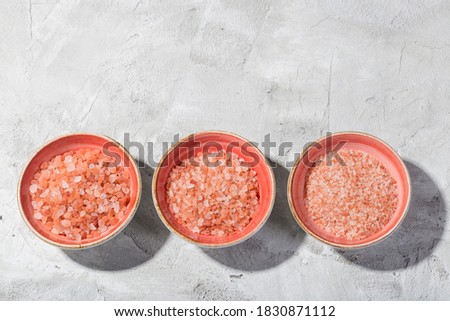 Himalayan pink salt in bowl on the table, close-up image