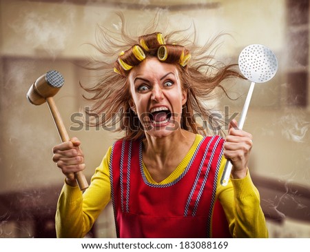 Crazy housewife with kitchen tools Royalty-Free Stock Photo #183088169