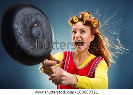 Crazy housewife with pan Royalty-Free Stock Photo #183089321