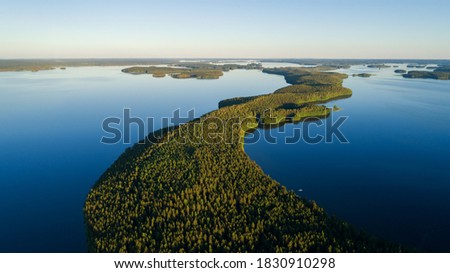 Beautiful scenery on picturesque lake with islands. Traditional Finnish and Scandinavian view. Popular tourist attraction. Drone shot.
