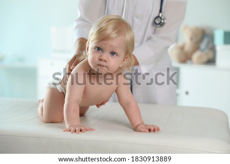 Pediatrician examining baby in hospital. Health care