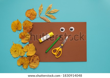 dry leaves applique art autumn. little child making autumn decoration "Owl" from leaves. Children's art project. DIY concept. Step-by-step photo instruction. Step 1