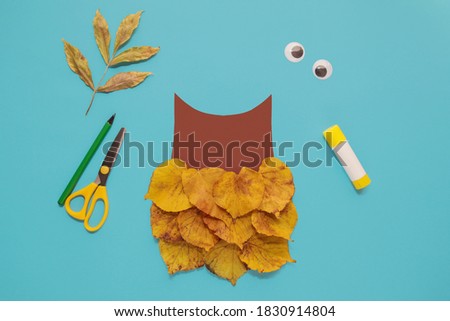 dry leaves applique art autumn. little child making autumn decoration "Owl" from leaves. Children's art project. DIY concept. Step-by-step photo instruction. Step 3