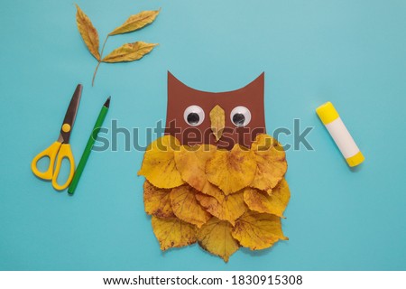 dry leaves applique art autumn. little child making autumn decoration "Owl" from leaves. Children's art project. DIY concept. Step-by-step photo instruction. Step 5
