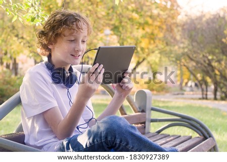 teenager 11 years old with a tablet