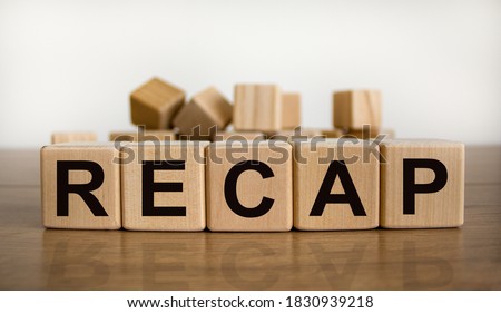 The word 'recap' on wooden cubes on beautiful wooden table, white background, copy space. Business concept.