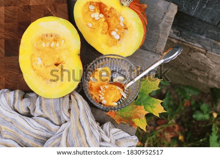 Cutting a bright orange pumpkin. Pumpkin seeds as a healthy food concept