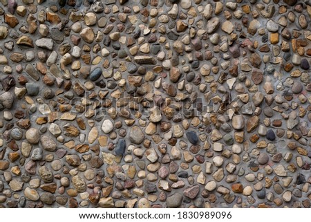 Marine rubble wall.Average stone size. Grey color.