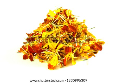 heaps of golden orange marigold flower petals in white background