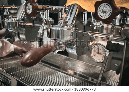 Close up of professional coffee machine. Brown handles and chrome surfaces of coffee machine