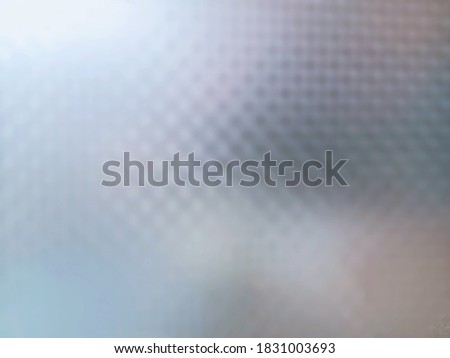 Blur mode shooting photo of the glass opaque film window surface with light and shadows. The abstract glass opaque film window background for decoration.