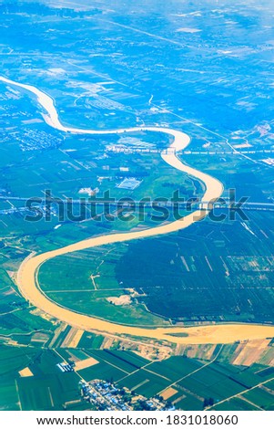 Aerial view of the green earth and winding river.