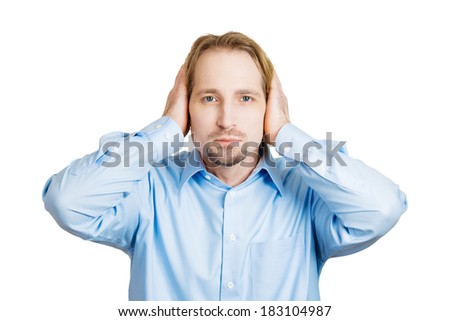 Closeup portrait handsome peaceful, tranquil, looking relaxed, young business man covering his ears, observing, isolated white background. Hear no evil concept. Human emotion, facial expressions