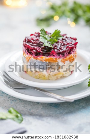 Shuba salad. Russian layered salad with beet, potato, carrot,  pickled herring and mayonnaise for Christmas dinner