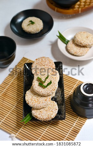 Traditional Chinese biscuits called Marie Wijen in Indonesia, is a food consist of double biscuits which dipped in a dissolved sugar and covered with roasted sesame seed. selective focus. top view