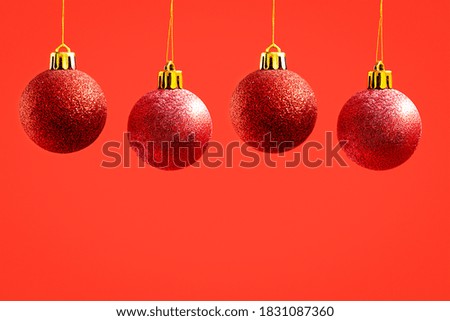 Christmas ornaments on a red background.