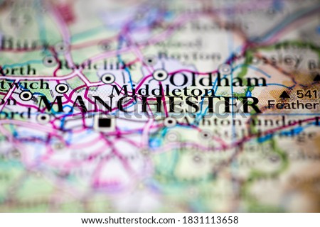 Shallow depth of field focus on geographical map location of Manchester city England United Kingdom Great Britain Europe continent on atlas