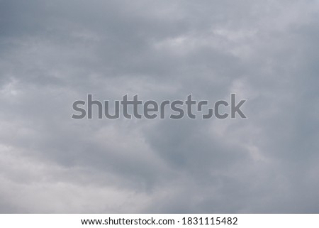 Grey sky. The sky is overhead. Clouds at sunset. The sky before the storm. Cumulus clouds. Gloomy sky. Open air.
