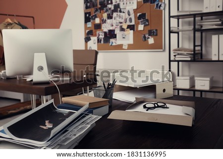 Crime scene photos and documents on table. Detective agency