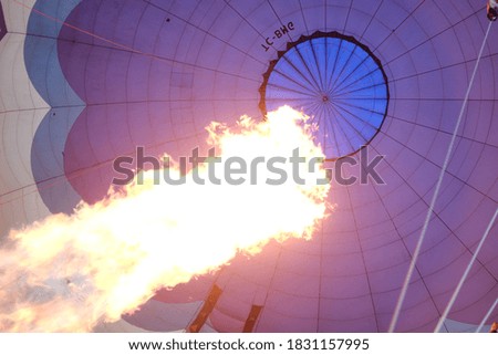 Flame shoots into a hot air balloon, close up