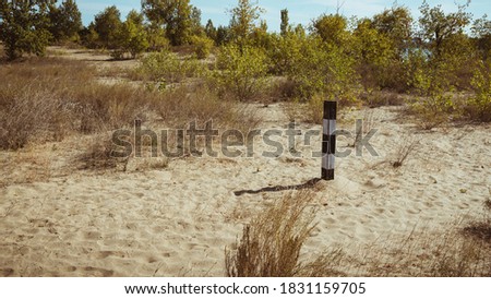 Border pillars in a desert sandy area - landscape