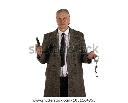studio portrait of male detective in gray coat