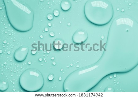 Cosmetic moisturizing liquid drops on green blue pastel background. Toner or lotion. Hyaluronic serum Royalty-Free Stock Photo #1831174942