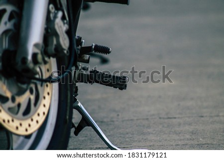 Closeup of a motorcycle rolling in the streets of the city center of the metropolitan area