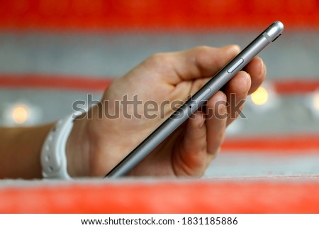 A close up of a hand holding a cellphone. High quality photo
