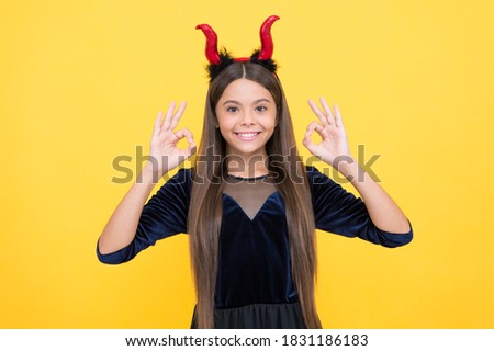happy witch devil kid show ok gesture wear imp horns costume on halloween party, happy halloween.