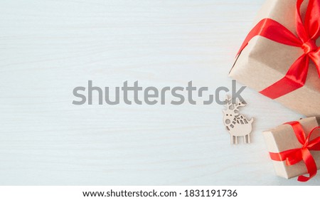 holiday gifts with wooden deer on wood background